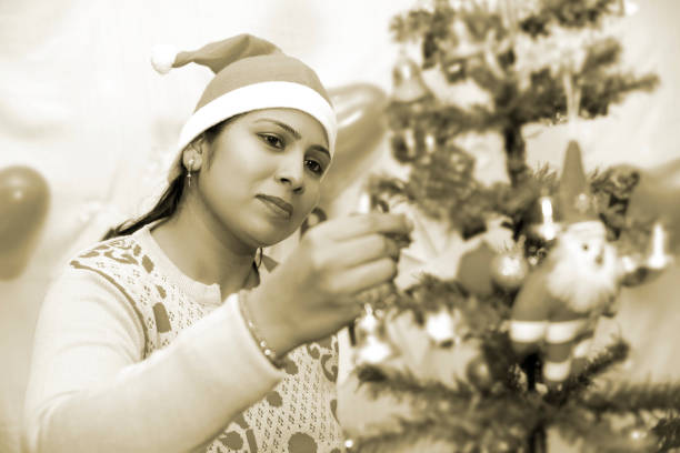 New Year's portrait of a beautiful teenage girl with a New Year's hat and Christmas lights
