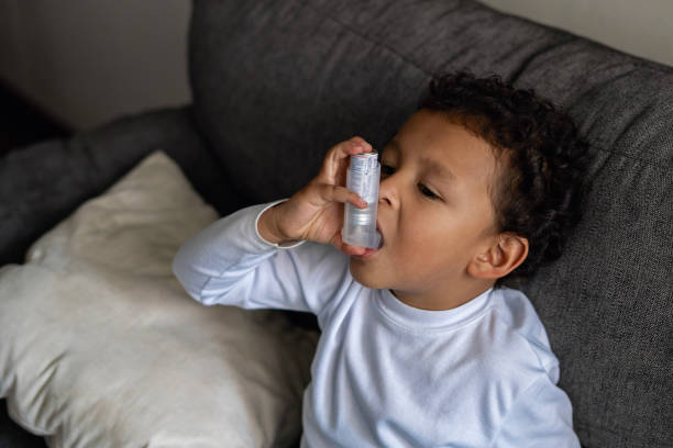 istock Child using an asthma inhaler for the first time. 1818420107