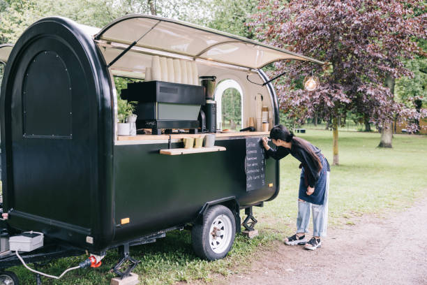 istock Japanese barista writing the menu on her coffee trailer 1818422003