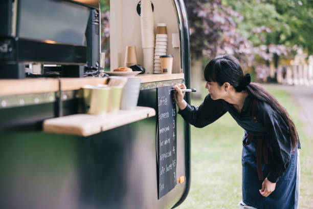 istock Japanese barista writing the menu on her coffee trailer 1818422053