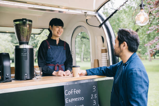 istock Japanese customer and mobile coffee trailer owner having a chat 1818422595