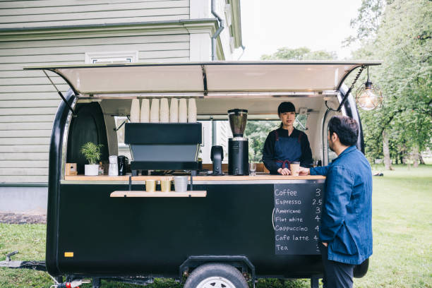 istock Japanese customer and mobile coffee trailer owner having a chat 1818422600