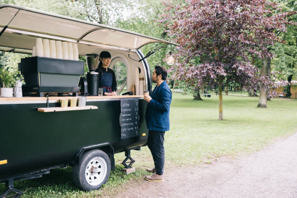 istock Japanese businessman paying at mobile coffee trailer 1818422602