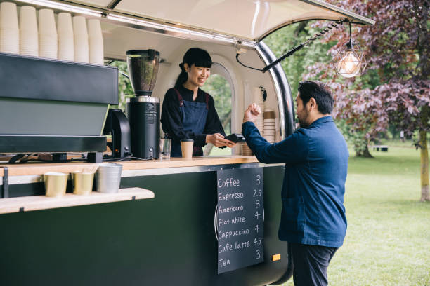 istock Japanese businessman paying at mobile coffee trailer 1818422609