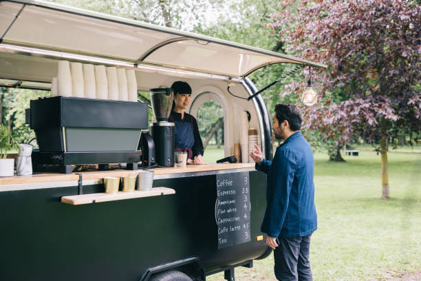 istock Japanese businessman paying at mobile coffee trailer 1818422613