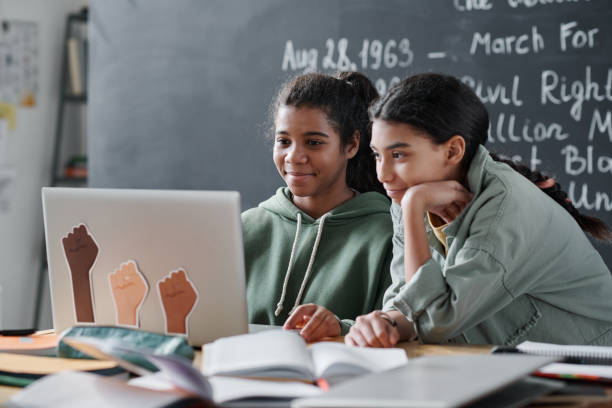 Schoolgirls using laptop to prepare for lesson