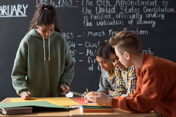 istock School children doing report in team 1818422643
