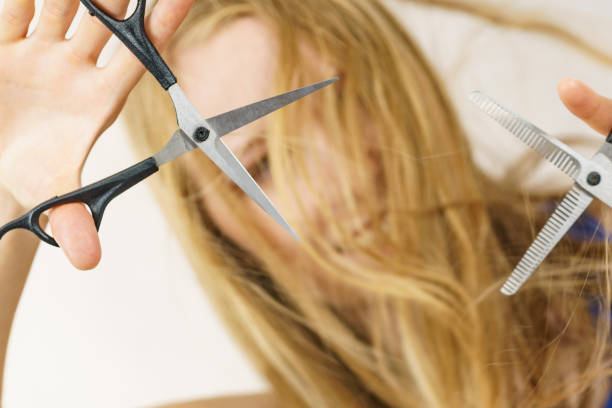 istock Girl with scissors for haircutting 1818433812