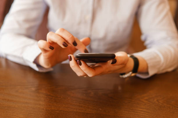istock Mobile phone in female hands. Beautiful women's manicure 1818433833