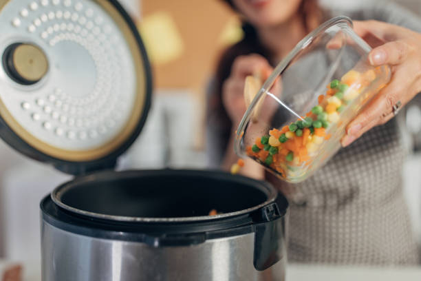 istock Hispanic woman using slow cooker while preparing food in the kitchen 1818446754