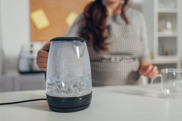 istock Hispanic woman boiling water in the kettle 1818448675
