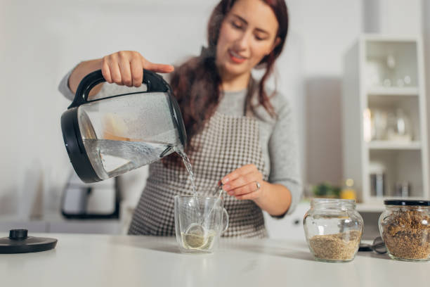 Hispanic woman boiling water in the kettle