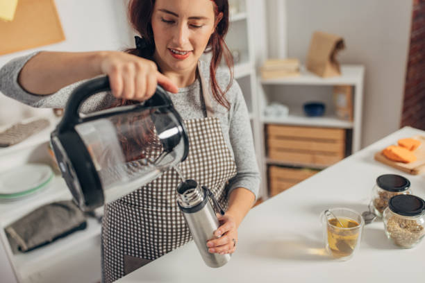 istock Hispanic woman boiling water in the kettle 1818452779