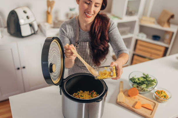 istock Hispanic woman using slow cooker while preparing food in the kitchen 1818460506