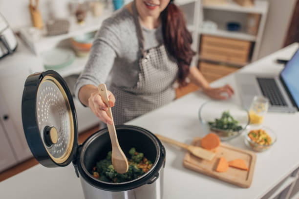 istock Hispanic woman using slow cooker while preparing food in the kitchen 1818463431