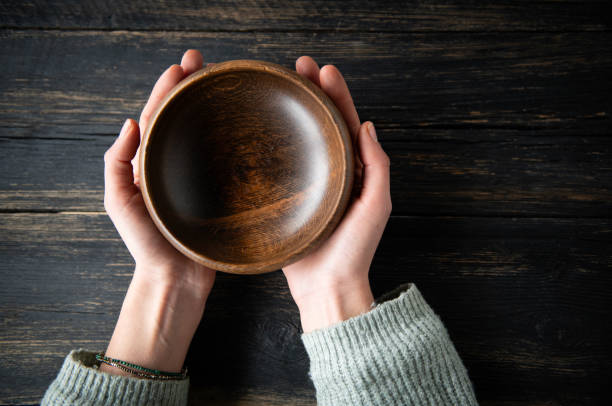 istock Woman hands holding empty wooden bowl 1818465096