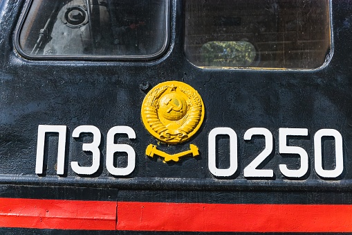 Text and numbers on a metal surface with the symbols of the USSR for design and commercial use.