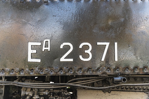 Text and numbers on a metal surface with the symbols of the USSR for design and commercial use.