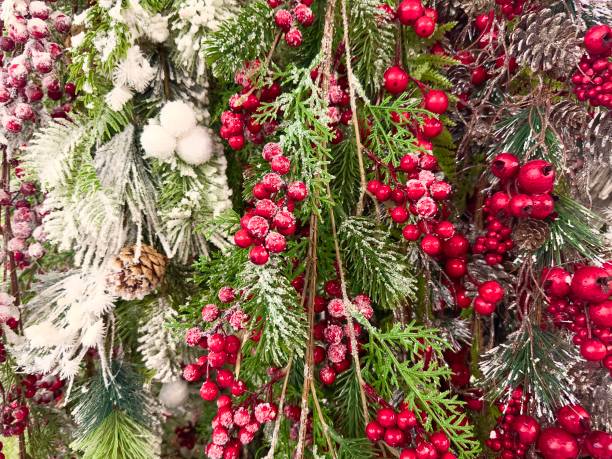istock Christmas background with red holly berries and pine cones covered with snow 1818487263
