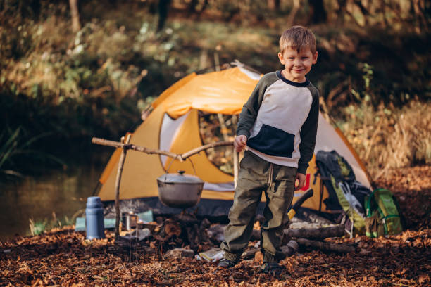 istock The boy near a tent and fire. Camping. 1818487613