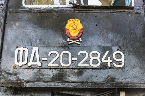 Text and numbers on a metal surface with the symbols of the USSR for design and commercial use.