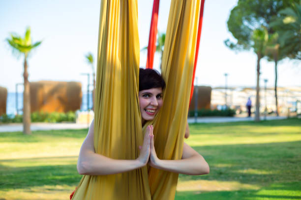 istock A woman took a yoga pose while doing aerial gymnastics on fabrics 1818488934