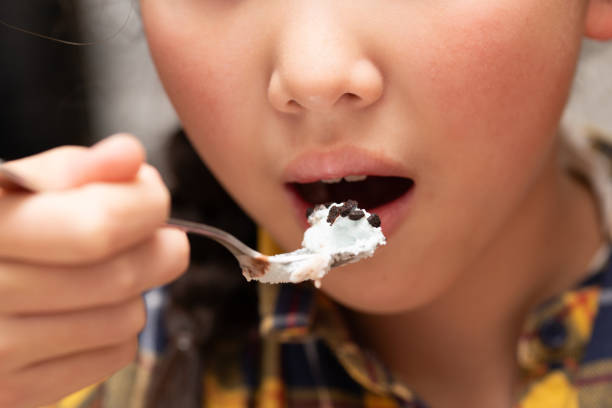 Little girl child eating candy