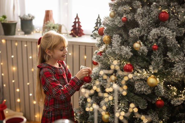 istock Little Girl Decorating Christmas Tree 1818493387