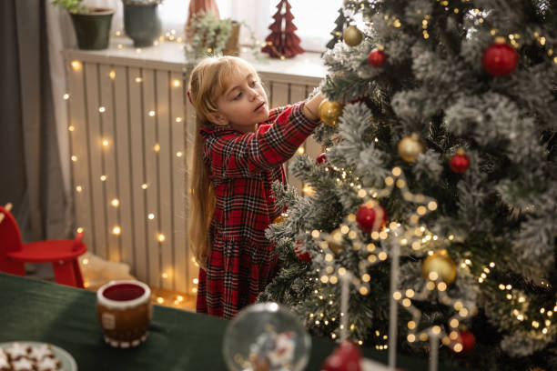 istock Little Girl Decorating Christmas Tree 1818493396