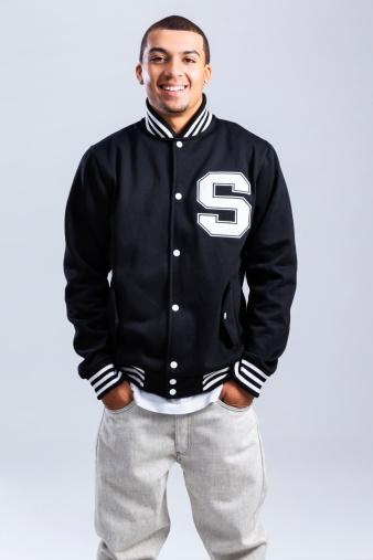 Photo of a young African Amercan male student in black letterman's jacket.