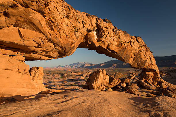 Sunset Arch in the Grand Staircase Escalante This unique arch is located in the Grand Staircase Escalante region of Utah. grand staircase escalante national monument stock pictures, royalty-free photos & images