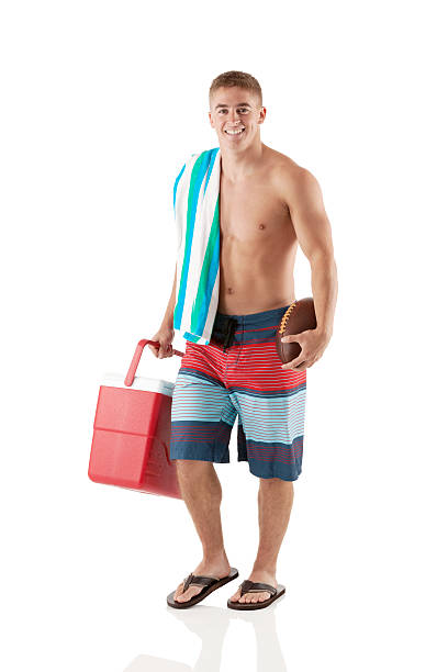 istock Smiling young man with a cooler and football 181851076