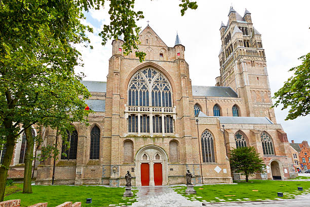 Sint-Salvator Cathedral in Bruges. "Sint-Salvator Cathedrall in  Bruges, Belgium. Wide angle view, backlit on a cloudy summer day. Bruges has most of its medieval architecture well preserved and has been designated a UNESCO World Heritage Site. It is the capital and largest city of the province of West Flanders." st salvator's cathedral stock pictures, royalty-free photos & images