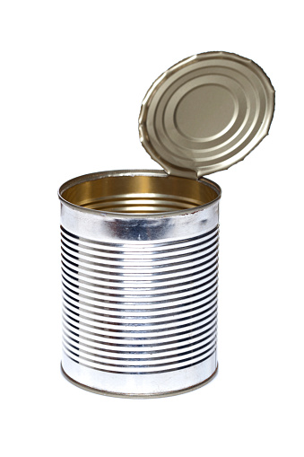 Metal cans with preserved meat. Food with a long shelf life. Dark background.