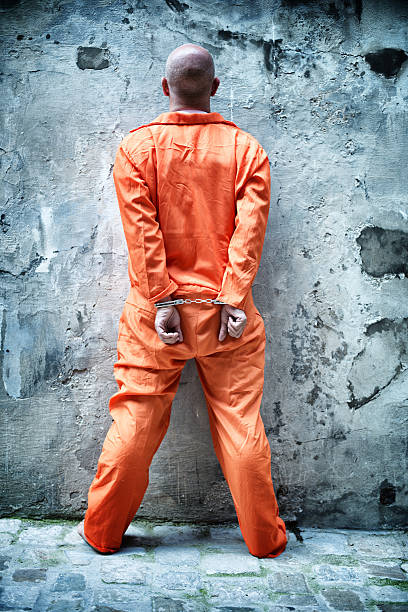 Handcuffed Prisoner in Orange Coveralls