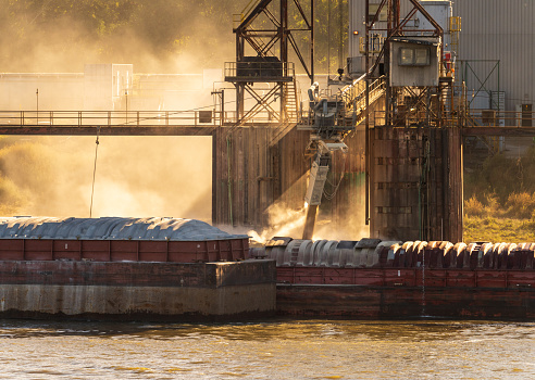 Grain being loaded into freight barges on Mississippi river
