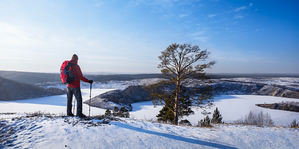 man with backpack in winter. hiking lifestyle adventure concept. panoramic banner.