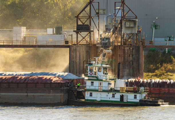 Grain being loaded into freight barges on Mississippi river