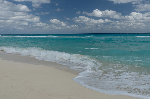 A beautiful shore line in Cancun Mexico with white sands and the blue water.