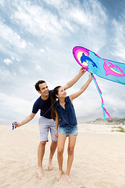 istock Father and daughter playing with a kite 181853914