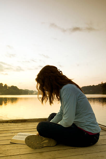 istock Young Woman Reading Bible 181854145