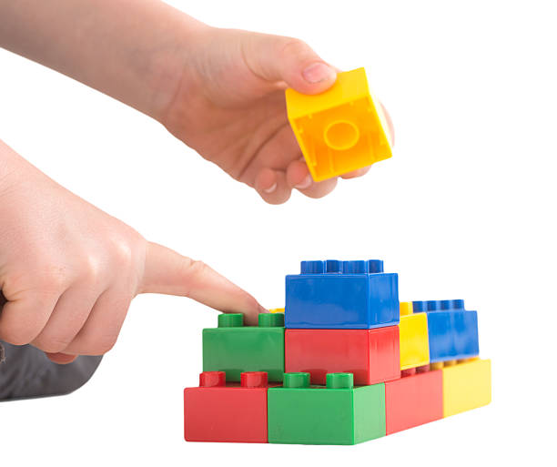 istock child hand is building with colored toy bricks 181854318