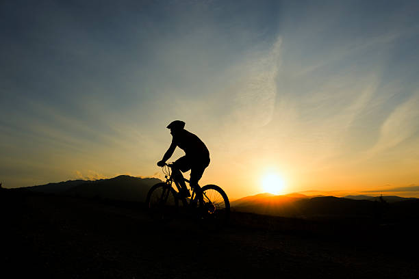 istock man silhouette on bike 181854657