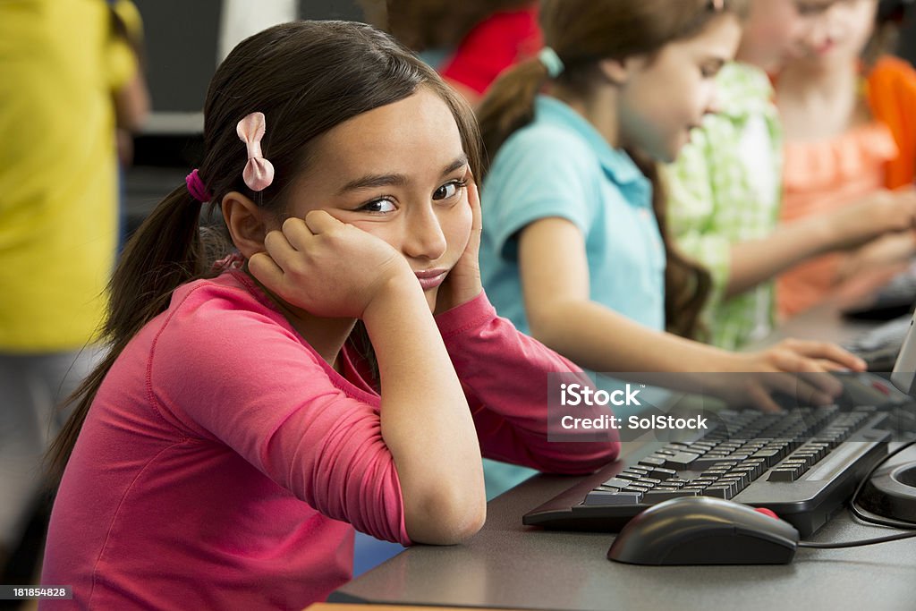 Child with Learning Difficulties "Asian Girl struggling at school, looking fed up" Classroom Stock Photo