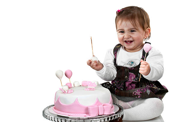 istock Cute baby girl first birthday cake 181854971
