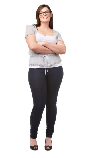 A pretty full-figured woman posing confidently on a white background