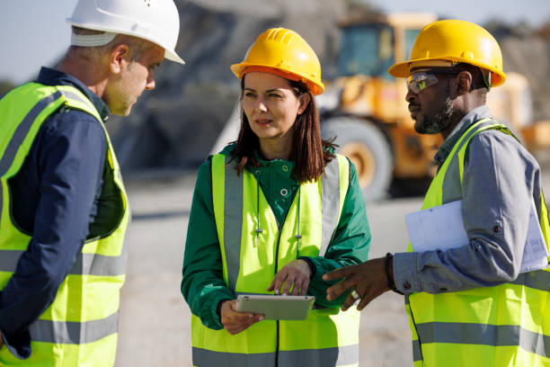 istock Team of engineers and an architect discussing at building site 1818561837