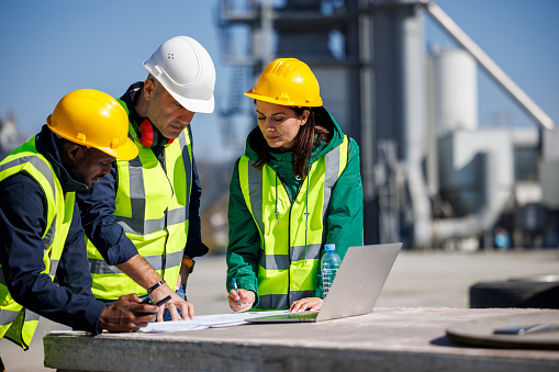 Engineers discussing at industrial facility