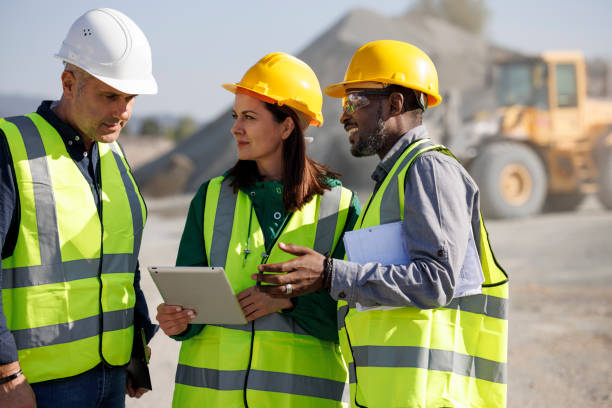 istock Team of engineers and an architect discussing at building site 1818561843