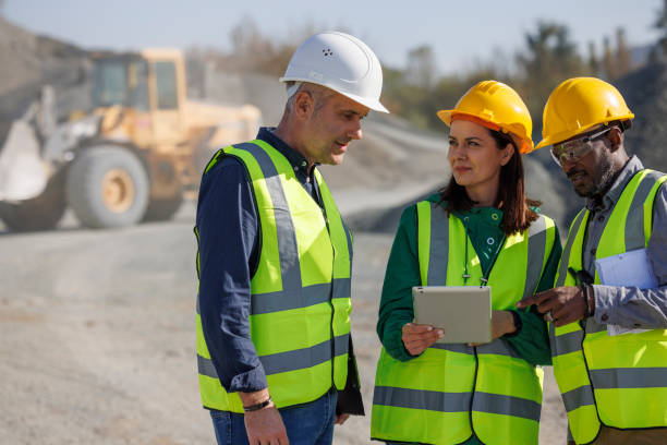 istock Team of engineers and an architect discussing at building site 1818561877